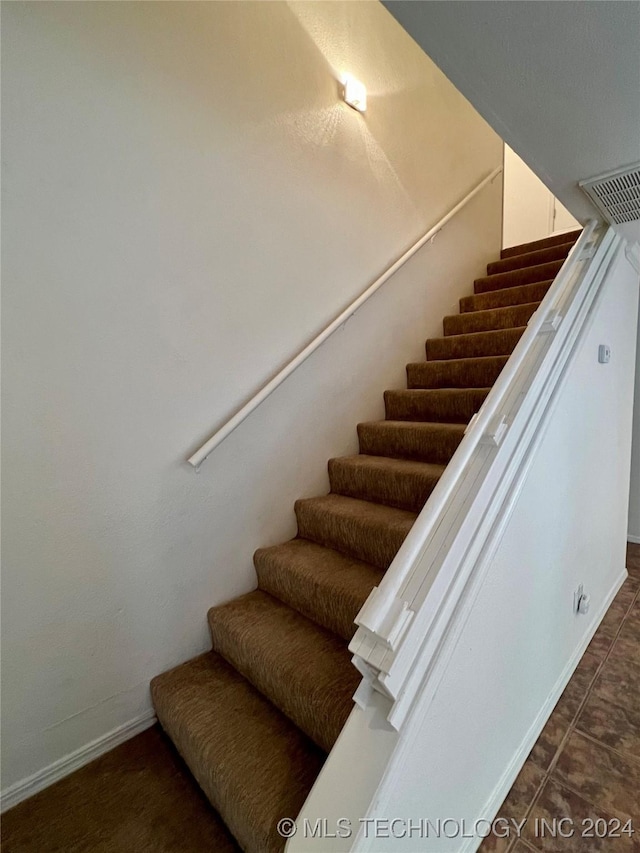 stairs with tile patterned flooring