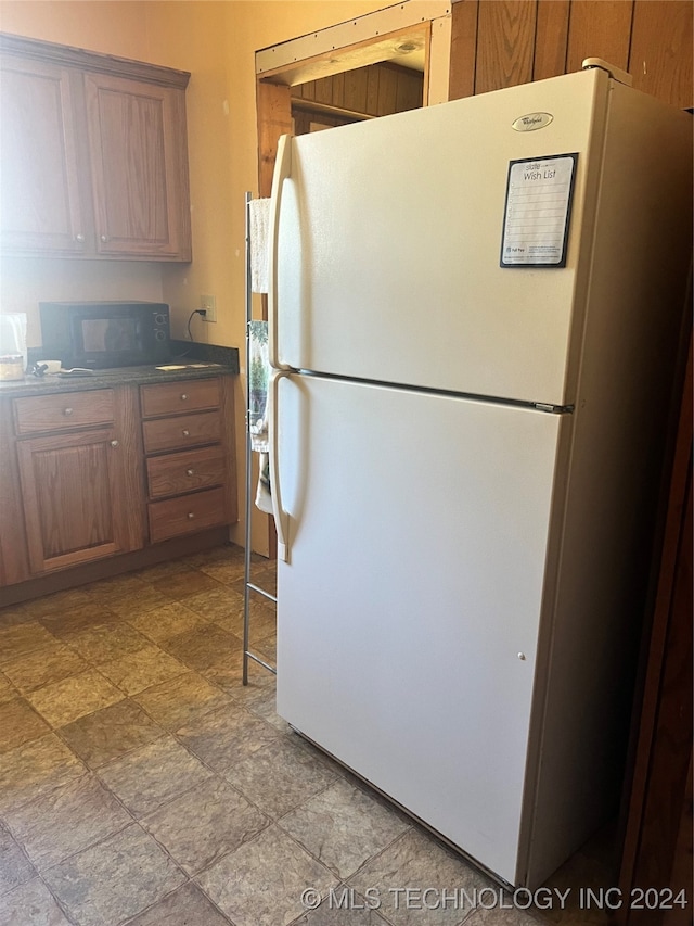 kitchen featuring white refrigerator and light tile patterned floors