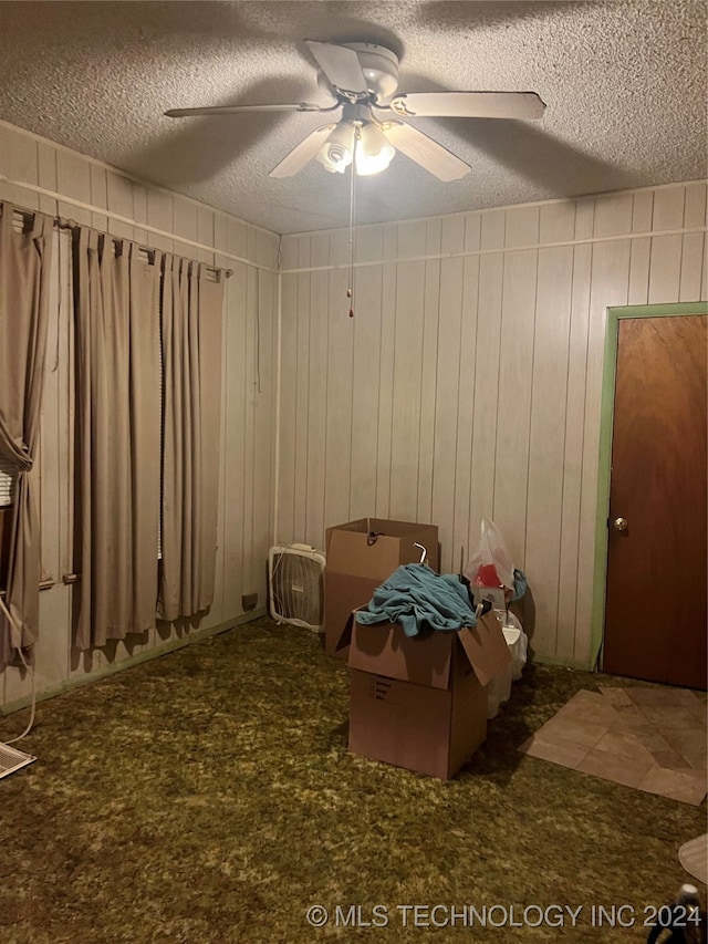 unfurnished bedroom with a textured ceiling and ceiling fan