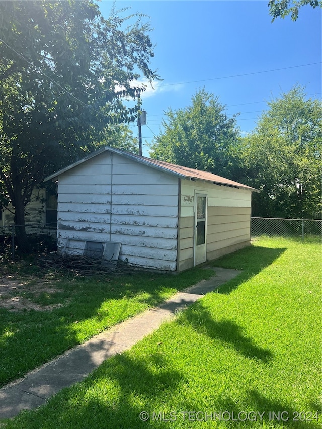 view of outbuilding with a yard