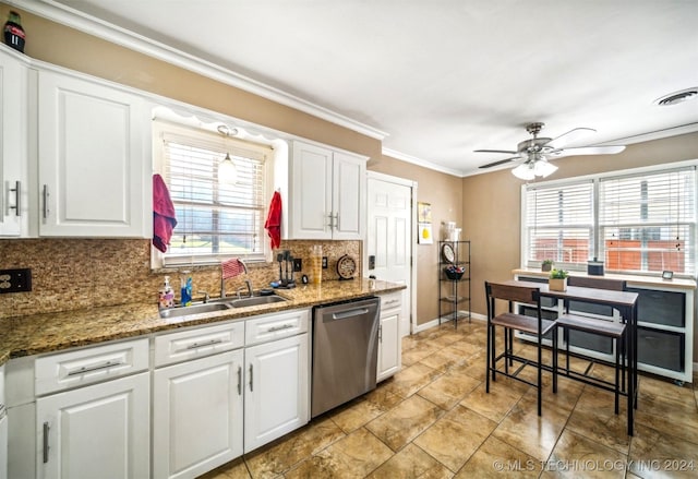 kitchen featuring ceiling fan, a wealth of natural light, tasteful backsplash, and stainless steel dishwasher