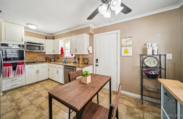 kitchen with white cabinetry, light tile patterned flooring, stainless steel appliances, and ceiling fan