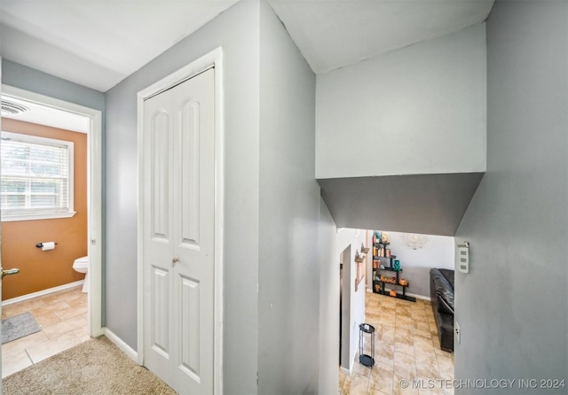 hall with light tile patterned flooring