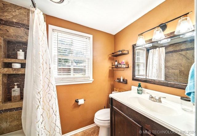 bathroom featuring vanity, toilet, and walk in shower