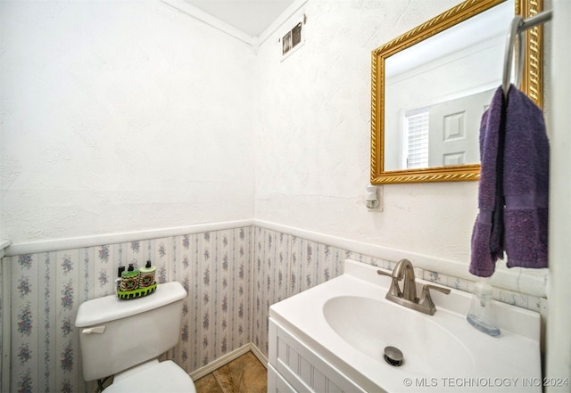 bathroom with vanity, toilet, and tile patterned floors