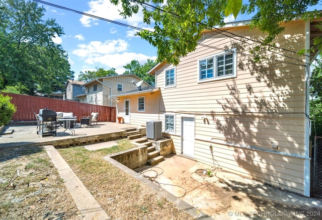 rear view of property featuring central AC, a patio, and a deck