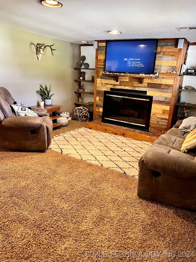 carpeted living room featuring a textured ceiling