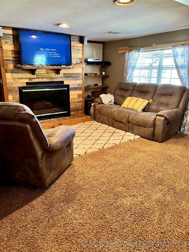 living room featuring a textured ceiling, wood walls, and carpet flooring