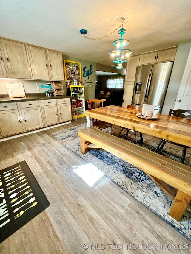 dining space featuring an inviting chandelier and light wood-type flooring