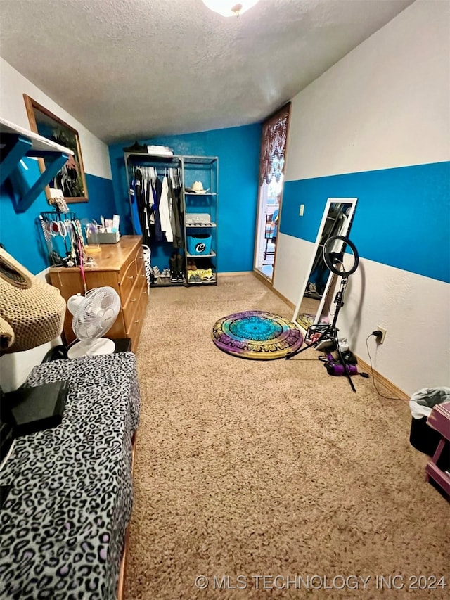 game room featuring a textured ceiling, lofted ceiling, and carpet flooring