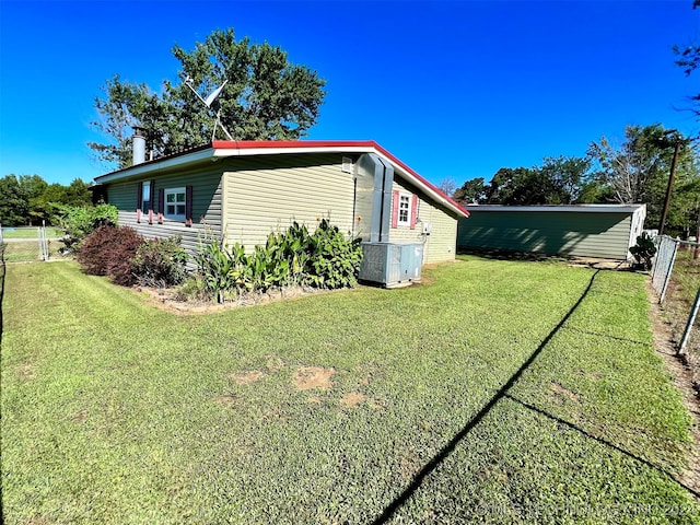 exterior space featuring a lawn and central air condition unit