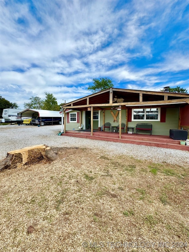 back of house with a carport