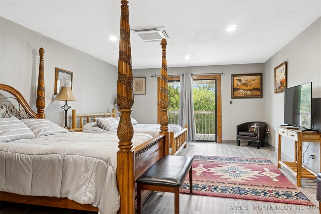 bedroom featuring light hardwood / wood-style floors and access to exterior