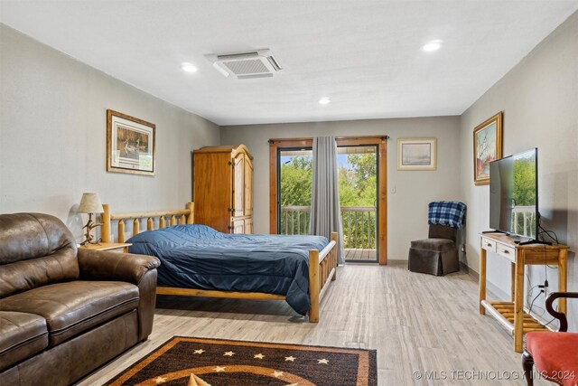 bedroom with light hardwood / wood-style flooring and access to outside