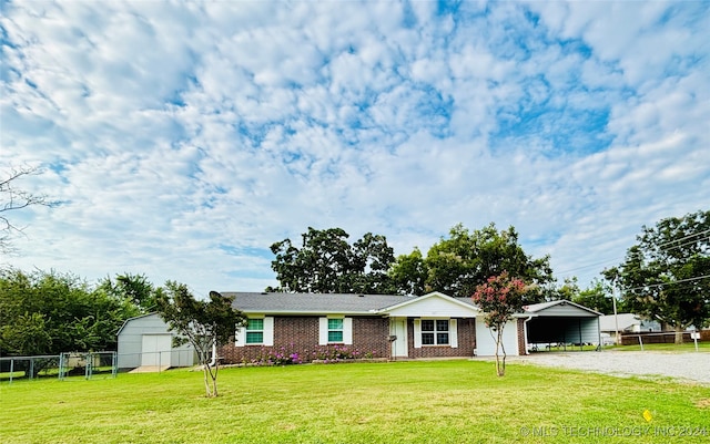 single story home with a shed and a front yard