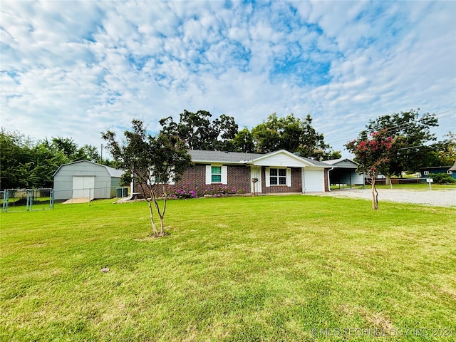 single story home featuring a storage unit and a front yard