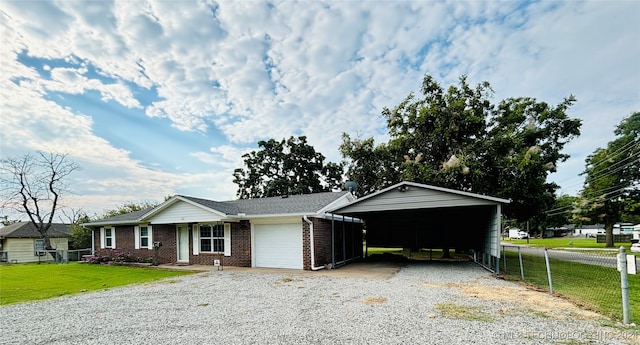 ranch-style house featuring a garage, a carport, and a front lawn