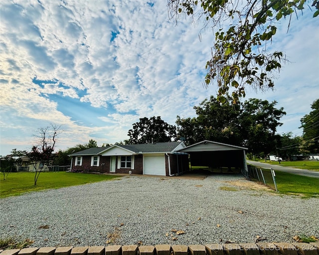 ranch-style house featuring a front yard and a garage