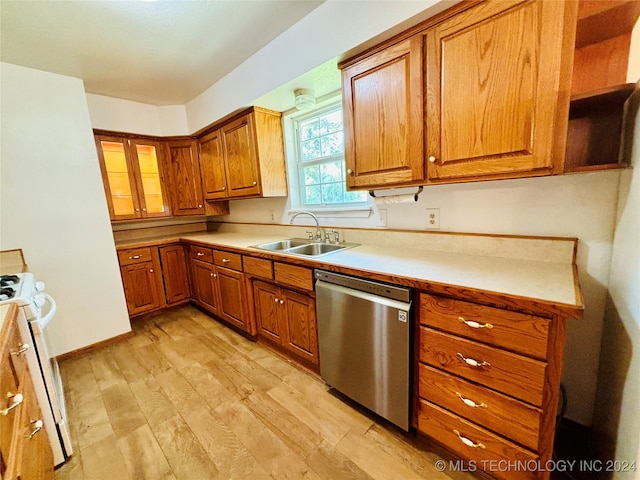 kitchen with light wood-type flooring, dishwasher, white stove, and sink