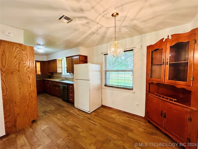 kitchen with dark hardwood / wood-style floors, pendant lighting, stainless steel dishwasher, a chandelier, and white refrigerator