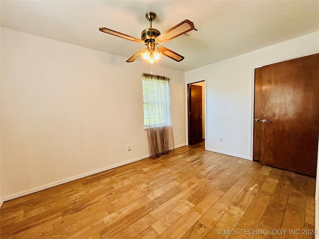 unfurnished bedroom with ceiling fan and light hardwood / wood-style flooring