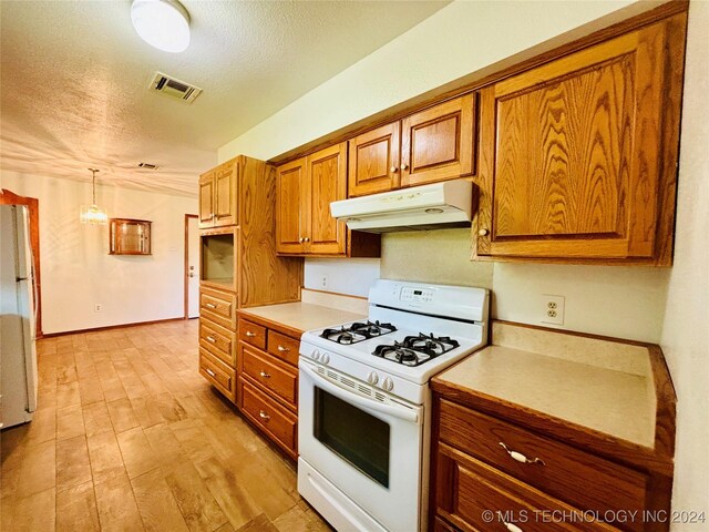 kitchen featuring a textured ceiling, hanging light fixtures, light wood-type flooring, and white range with gas cooktop