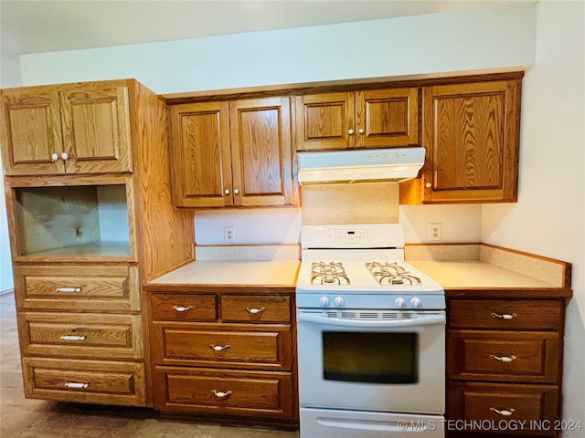 kitchen with dark tile patterned flooring and electric stove