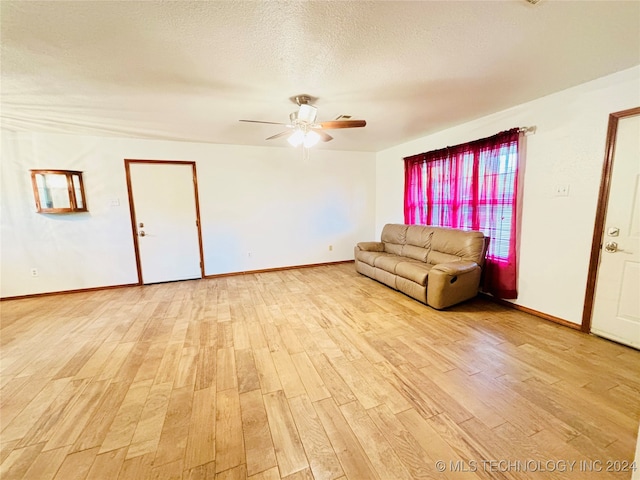 unfurnished living room featuring light wood-type flooring, a textured ceiling, and ceiling fan