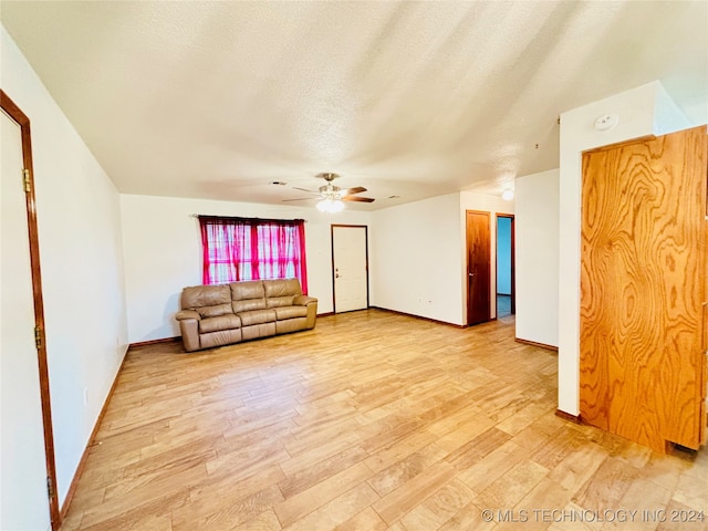 interior space featuring a textured ceiling, ceiling fan, and light hardwood / wood-style floors