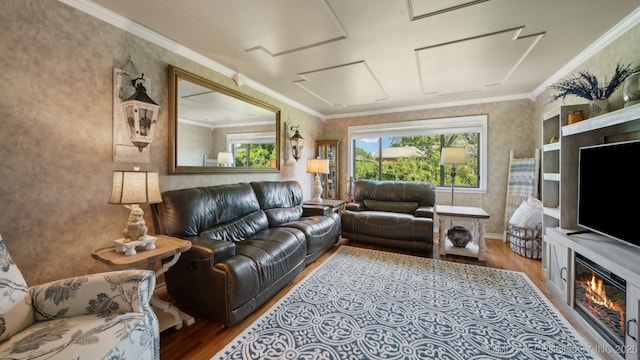 living room with crown molding and light hardwood / wood-style floors