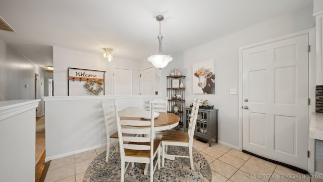 dining space featuring light tile patterned floors