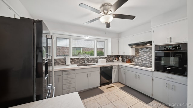 kitchen with sink, gray cabinetry, backsplash, light tile patterned floors, and black appliances