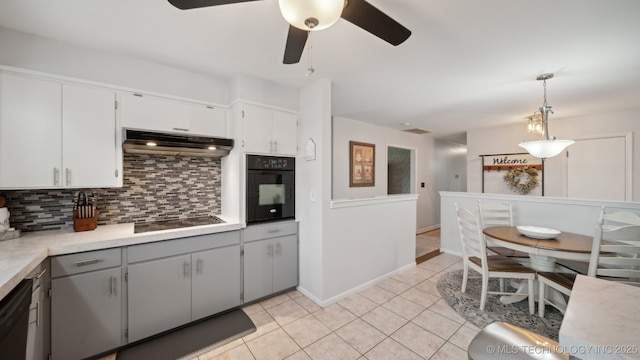 kitchen with pendant lighting, white cabinets, backsplash, and black appliances