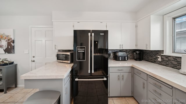 kitchen featuring light tile patterned floors, gray cabinets, white cabinetry, tasteful backsplash, and black refrigerator with ice dispenser