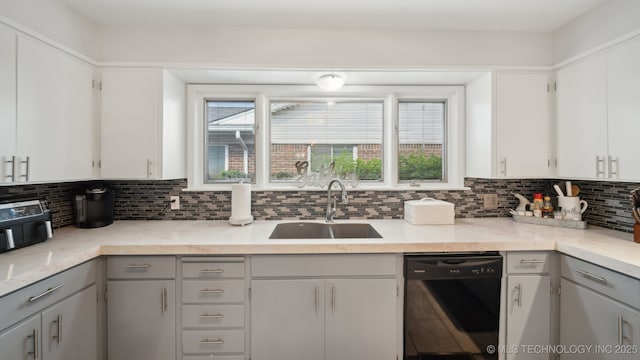 kitchen with sink, dishwasher, gray cabinetry, white cabinets, and decorative backsplash