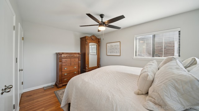 bedroom with hardwood / wood-style flooring and ceiling fan