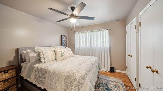 bedroom with light hardwood / wood-style flooring and ceiling fan