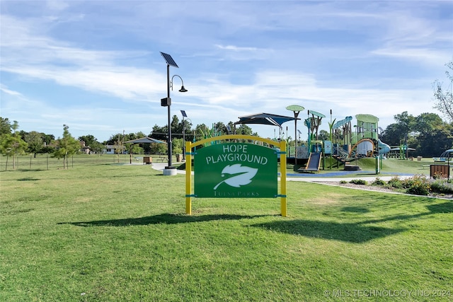 view of home's community with a lawn and a playground