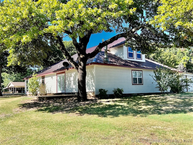 view of home's exterior with a yard