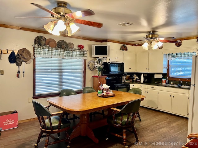 dining area with a healthy amount of sunlight, ceiling fan, and wood-type flooring