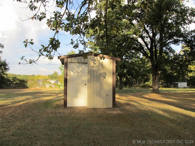 view of outbuilding with a lawn