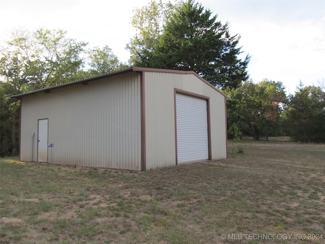 view of outbuilding with a lawn and a garage