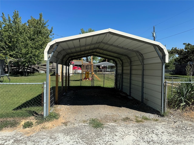 view of parking / parking lot featuring a lawn and a carport