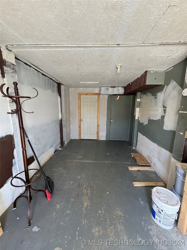 basement featuring a textured ceiling