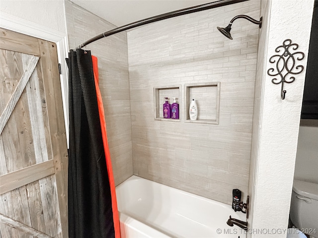 bathroom with toilet and shower / tub combo with curtain