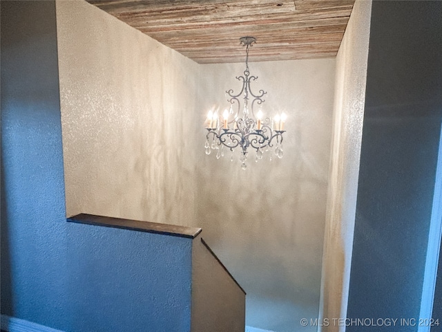 room details with wooden ceiling and a notable chandelier