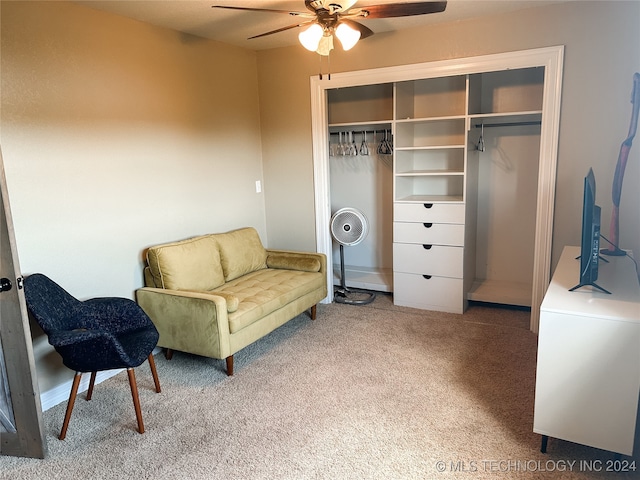 living area featuring carpet flooring and ceiling fan