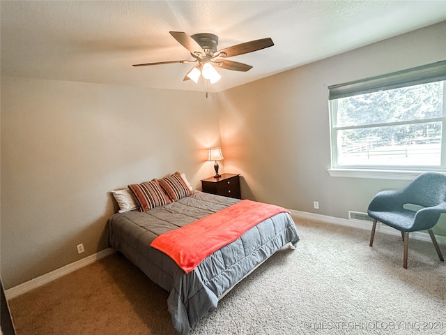 bedroom featuring ceiling fan and carpet