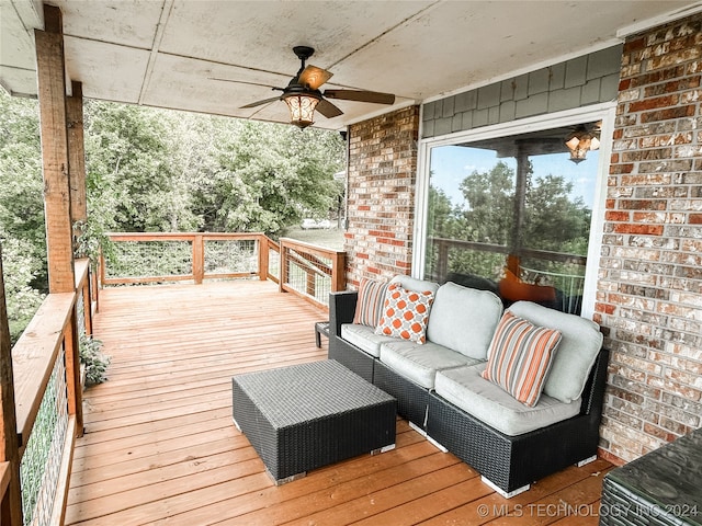 wooden terrace with ceiling fan and an outdoor hangout area