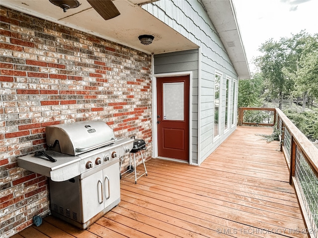 wooden terrace with ceiling fan and a grill